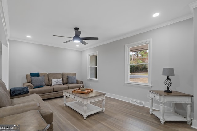 living room featuring ceiling fan, wood-type flooring, and ornamental molding