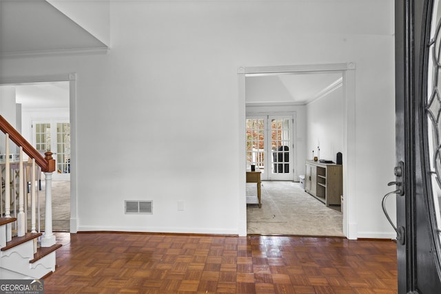 entryway featuring french doors, dark parquet floors, and ornamental molding