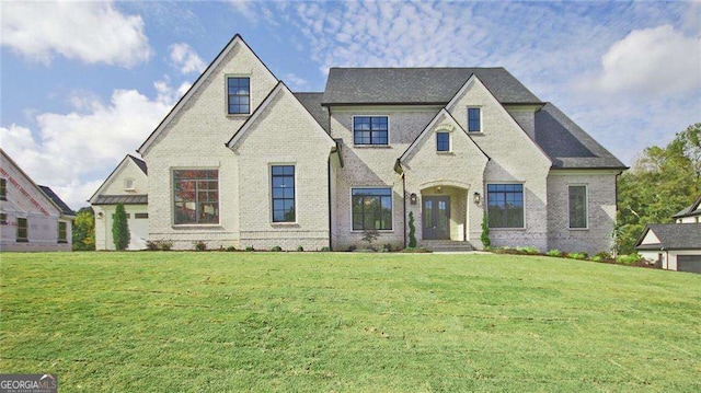 french country home featuring a front lawn