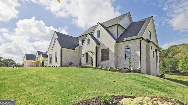 french country style house featuring a front yard