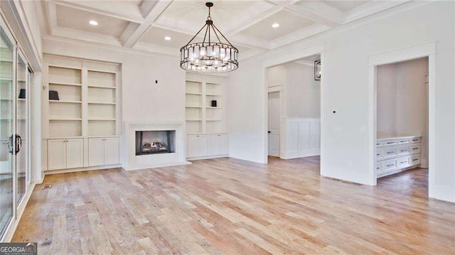 unfurnished living room featuring beamed ceiling, a notable chandelier, light hardwood / wood-style floors, and coffered ceiling