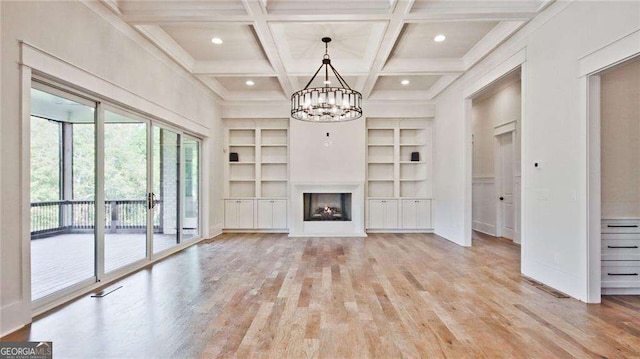 unfurnished living room featuring beamed ceiling, light wood-type flooring, a chandelier, and coffered ceiling