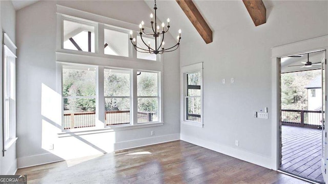 unfurnished dining area with ceiling fan with notable chandelier, beam ceiling, dark hardwood / wood-style flooring, and high vaulted ceiling