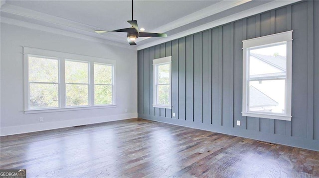 spare room featuring plenty of natural light, dark wood-type flooring, and ceiling fan