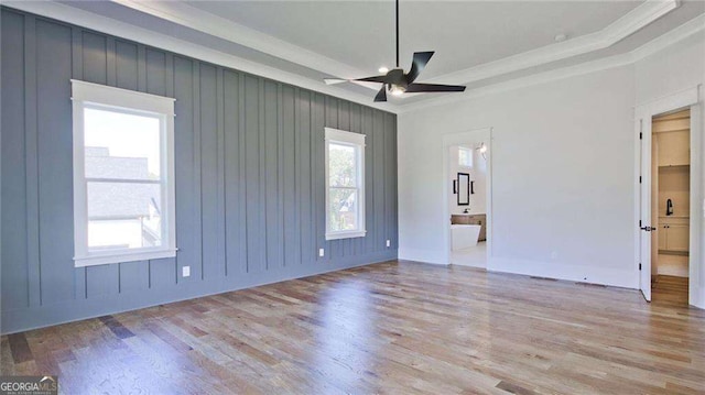 unfurnished room with light wood-type flooring, a wealth of natural light, and ceiling fan