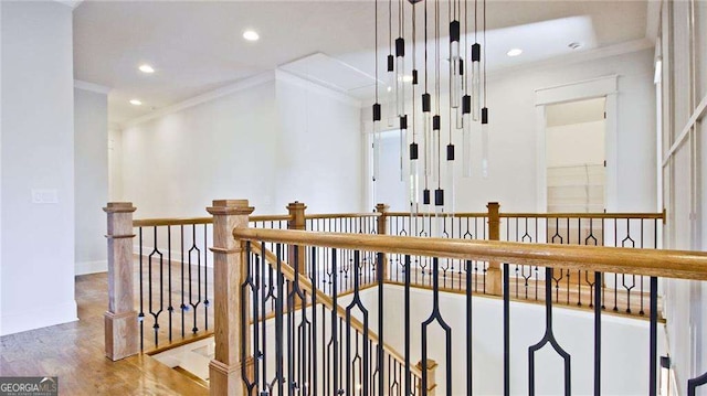 hallway with hardwood / wood-style flooring and ornamental molding