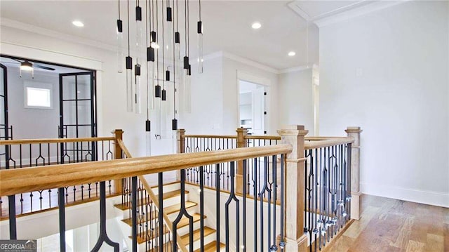 hall with hardwood / wood-style floors and ornamental molding