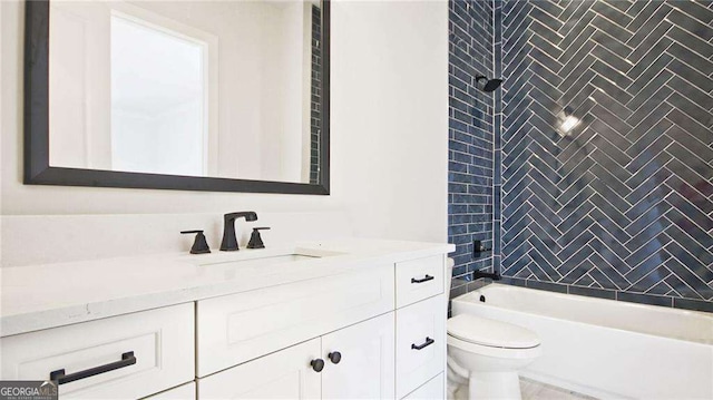 full bathroom featuring toilet, vanity, and tiled shower / bath