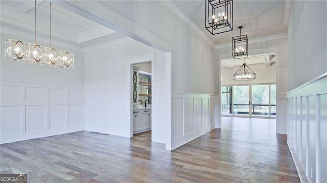 interior space with crown molding, hardwood / wood-style floors, a high ceiling, and sink