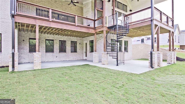 rear view of property with ceiling fan, a yard, and a patio