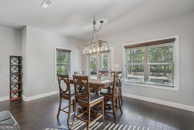 dining space featuring a chandelier, dark hardwood / wood-style floors, and plenty of natural light