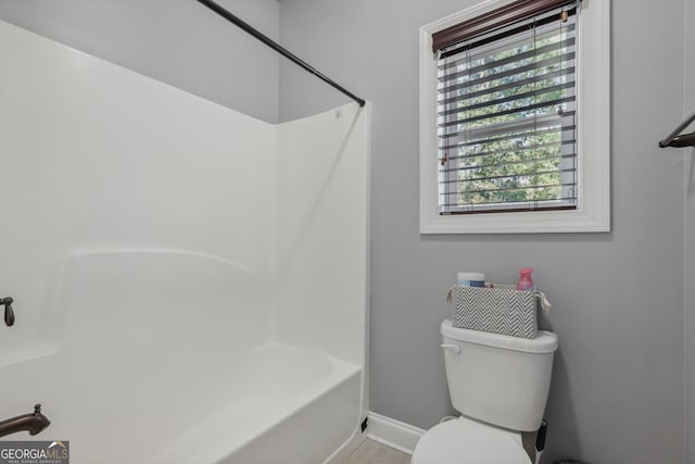 bathroom with toilet and bathtub / shower combination