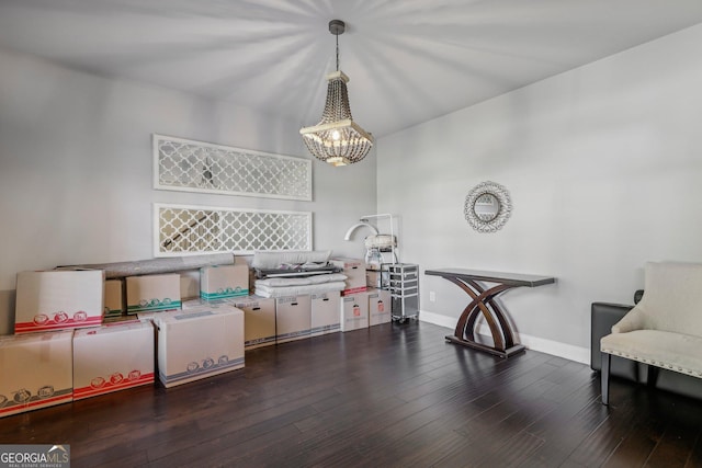 living area featuring dark hardwood / wood-style floors and a notable chandelier