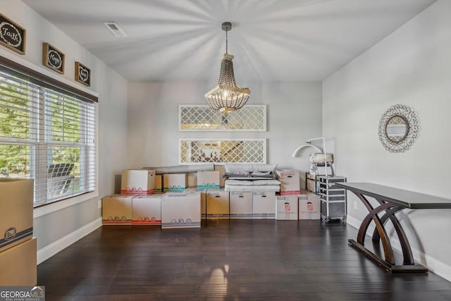 interior space featuring dark hardwood / wood-style flooring and an inviting chandelier