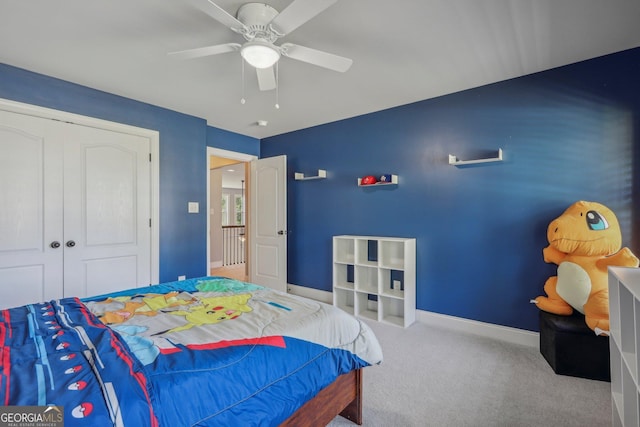 carpeted bedroom featuring ceiling fan and a closet