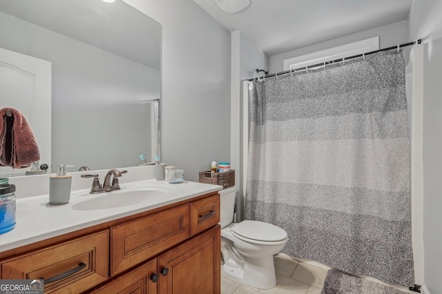 bathroom featuring tile patterned flooring, a shower with curtain, vanity, and toilet