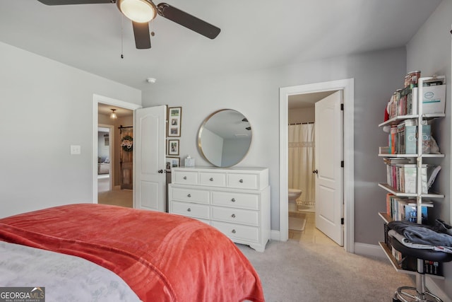 carpeted bedroom featuring ensuite bathroom and ceiling fan