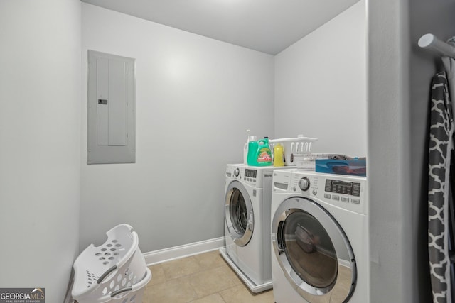 laundry area featuring light tile patterned floors, electric panel, and washer and clothes dryer