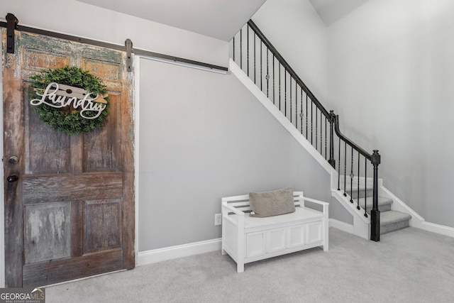 stairs featuring carpet flooring and a barn door