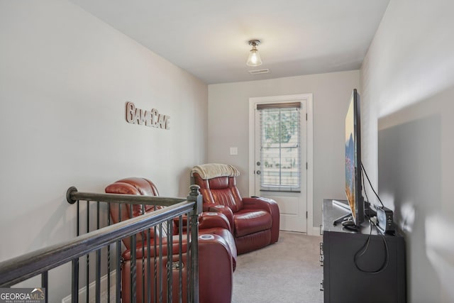 carpeted bedroom featuring a crib