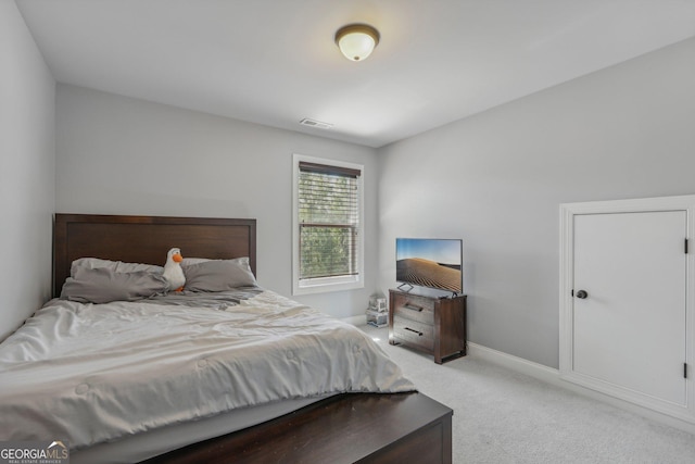 bedroom with light colored carpet