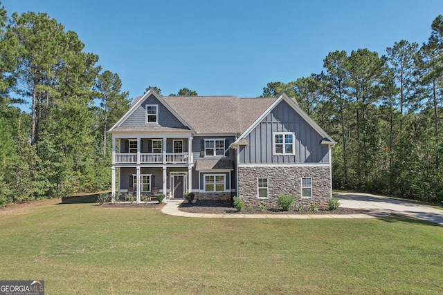 view of front of property with a porch, a balcony, and a front lawn