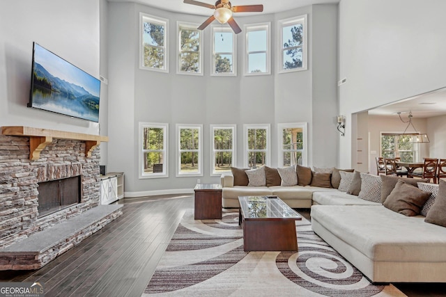 living room with a fireplace, dark hardwood / wood-style flooring, and a healthy amount of sunlight