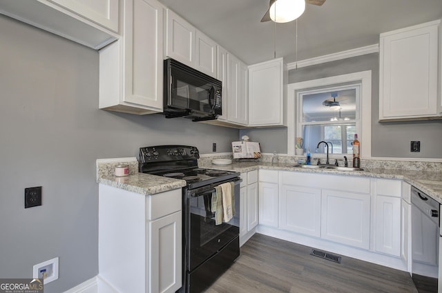 kitchen featuring dark wood-type flooring, sink, white cabinets, and black appliances