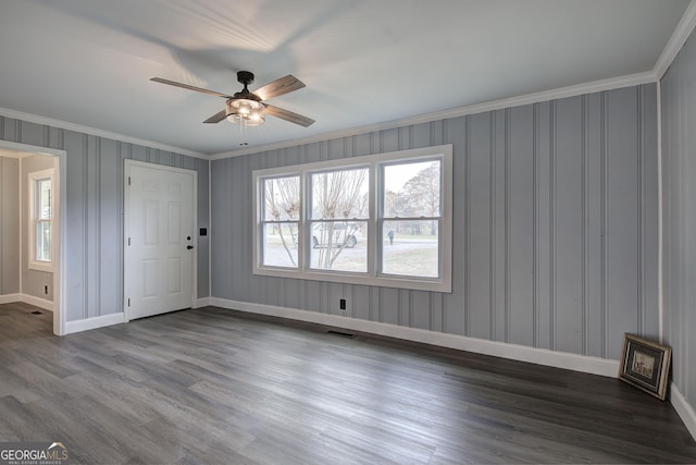 unfurnished room with dark hardwood / wood-style floors, ceiling fan, and ornamental molding