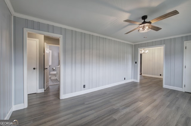 spare room with crown molding, ceiling fan with notable chandelier, and hardwood / wood-style flooring