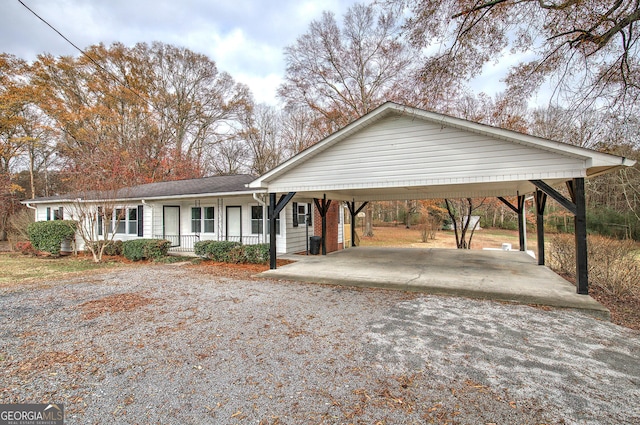 ranch-style home with a carport and covered porch