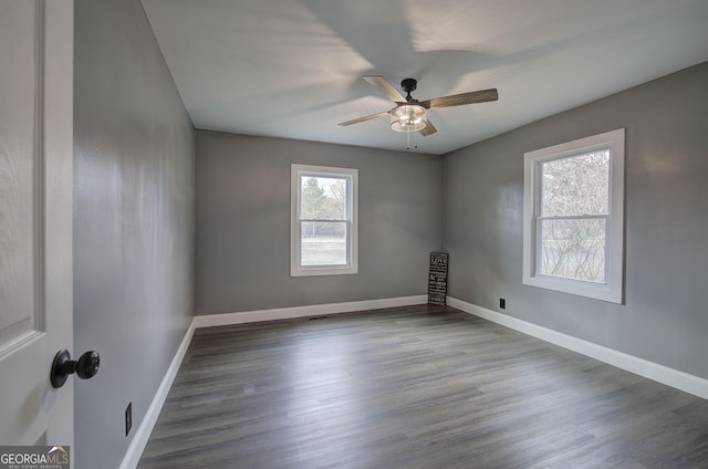 empty room featuring dark hardwood / wood-style floors and ceiling fan