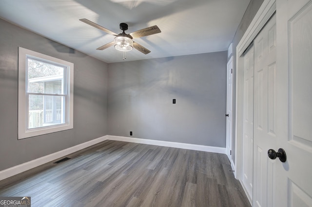 interior space featuring hardwood / wood-style floors, a closet, and ceiling fan