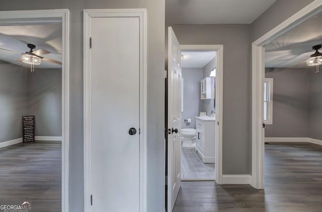 hallway with dark hardwood / wood-style flooring and sink