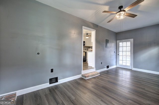 empty room featuring ceiling fan and dark hardwood / wood-style flooring