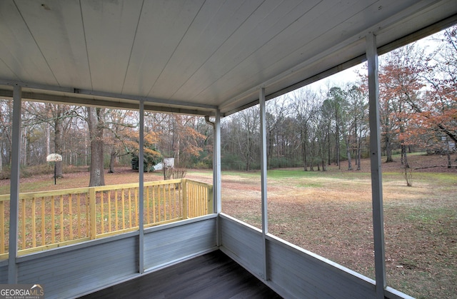 unfurnished sunroom with wood ceiling and a healthy amount of sunlight