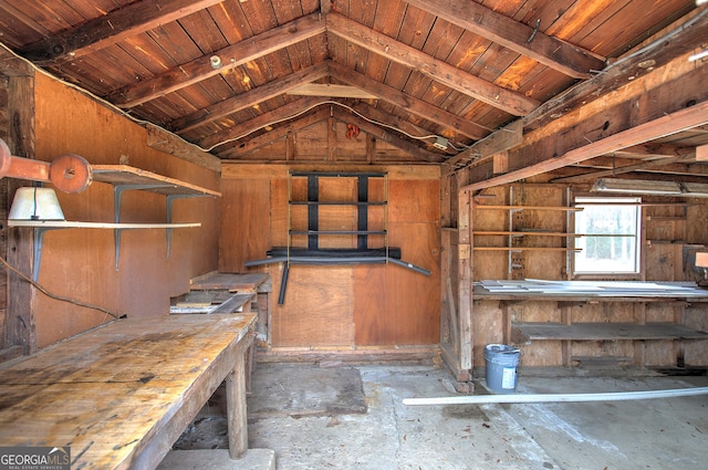 misc room with vaulted ceiling with beams, wood ceiling, and a workshop area