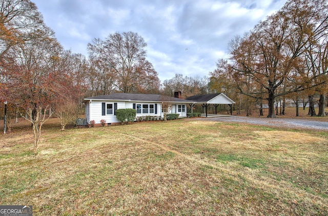 single story home featuring a carport and a front lawn