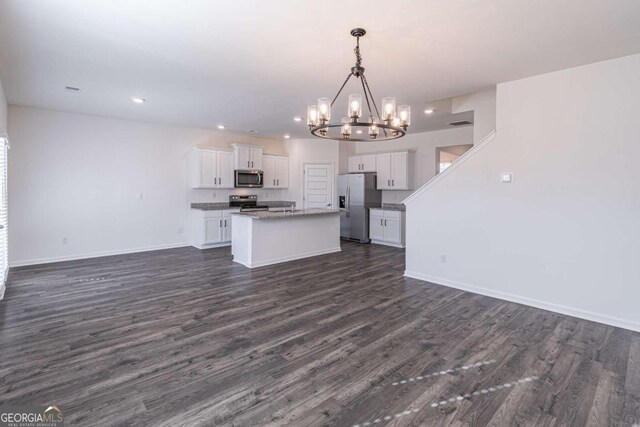 kitchen featuring pendant lighting, a center island, white cabinets, dark hardwood / wood-style flooring, and stainless steel appliances