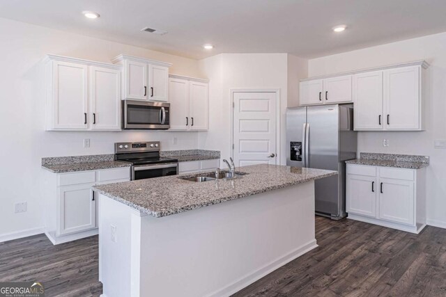 kitchen featuring dark hardwood / wood-style flooring, stainless steel appliances, sink, a center island with sink, and white cabinetry