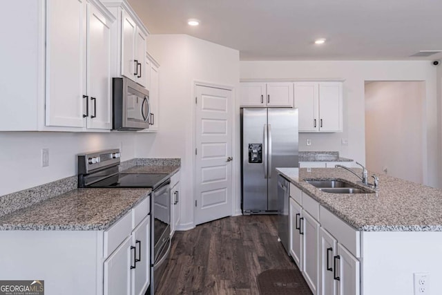 kitchen with white cabinets, sink, appliances with stainless steel finishes, and dark wood-type flooring