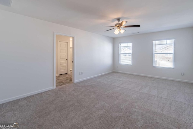 empty room with ceiling fan and light carpet