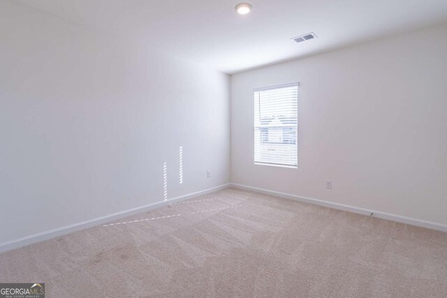 spare room with light colored carpet