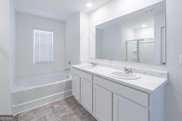 bathroom featuring vanity and shower with separate bathtub