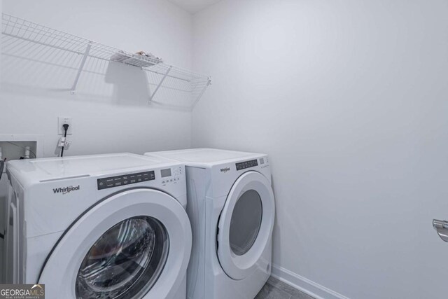 clothes washing area with washing machine and dryer