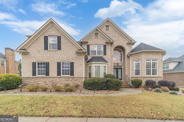 view of front of home with a front yard and french doors