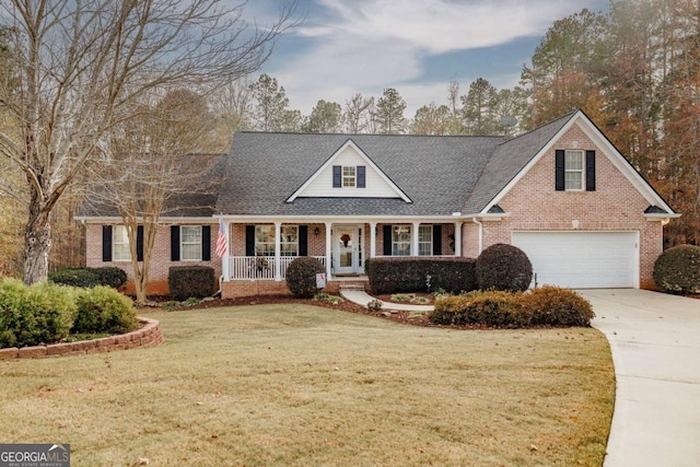 view of front of home featuring a porch, a garage, and a front yard