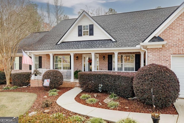 view of front facade with covered porch and a garage