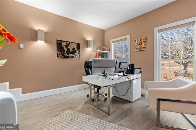 dining space featuring crown molding and light hardwood / wood-style flooring