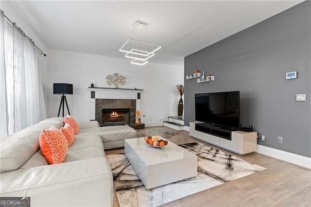 living room with hardwood / wood-style floors and a high end fireplace